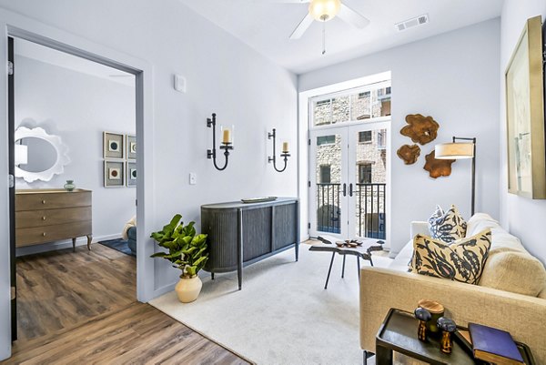 Modern living room with sunlit interiors at Avvio Apartments, a Greystar luxury community