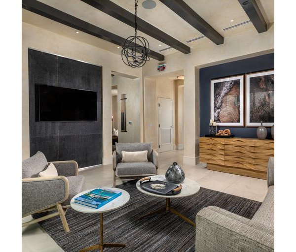 Modern clubhouse with cozy seating and large windows at The Core on Foothill Apartments