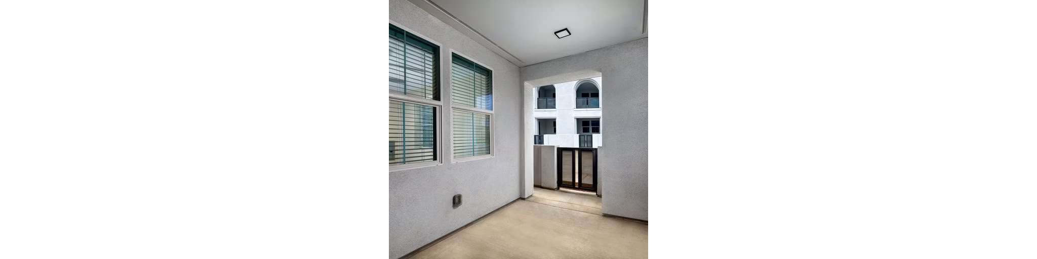 Spacious open kitchen with modern appliances and island counter at The Core on Foothill Apartments