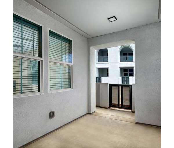 Spacious open kitchen with modern appliances and island counter at The Core on Foothill Apartments