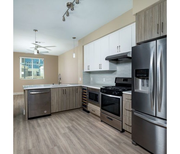 Modern kitchen with stainless steel appliances and granite countertops at The Core on Foothill Apartments, Greystar luxury living