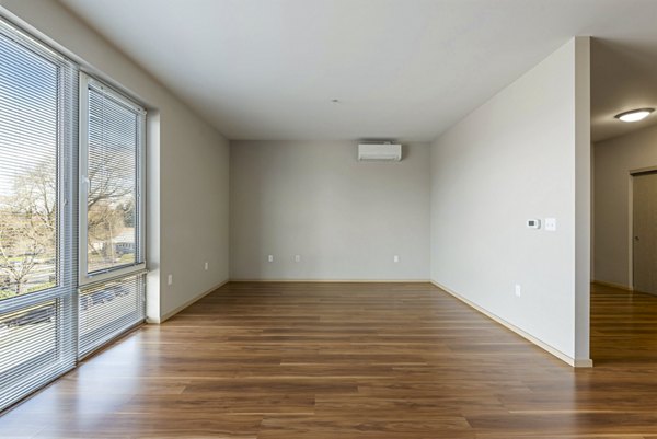 Cozy bedroom with contemporary decor and large windows at Prescott Apartments