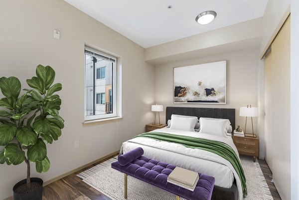 Cozy bedroom with modern furnishings in Prescott Apartments, a luxury living community by Greystar
