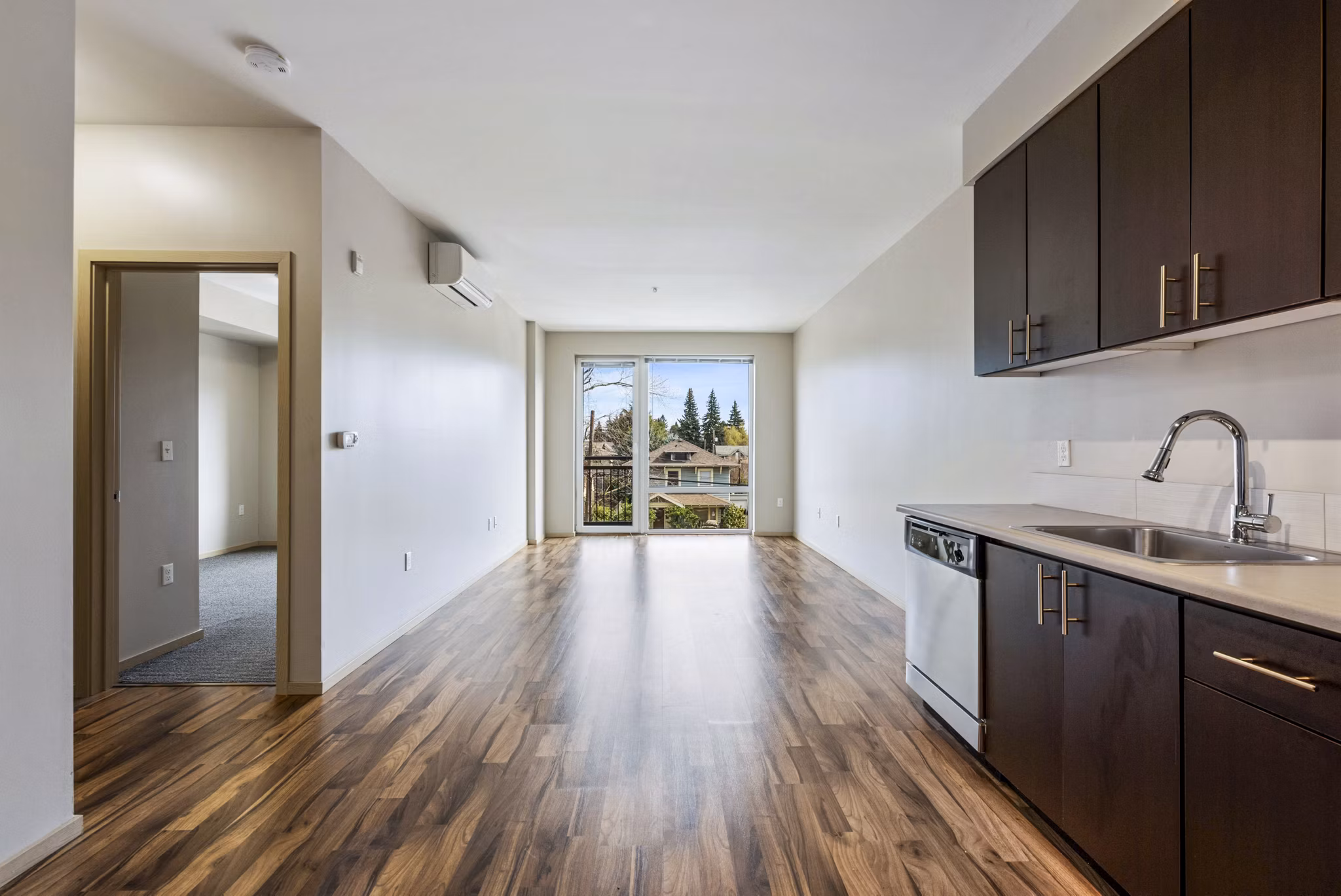 Modern kitchen featuring stainless steel appliances and granite countertops at Prescott Apartments