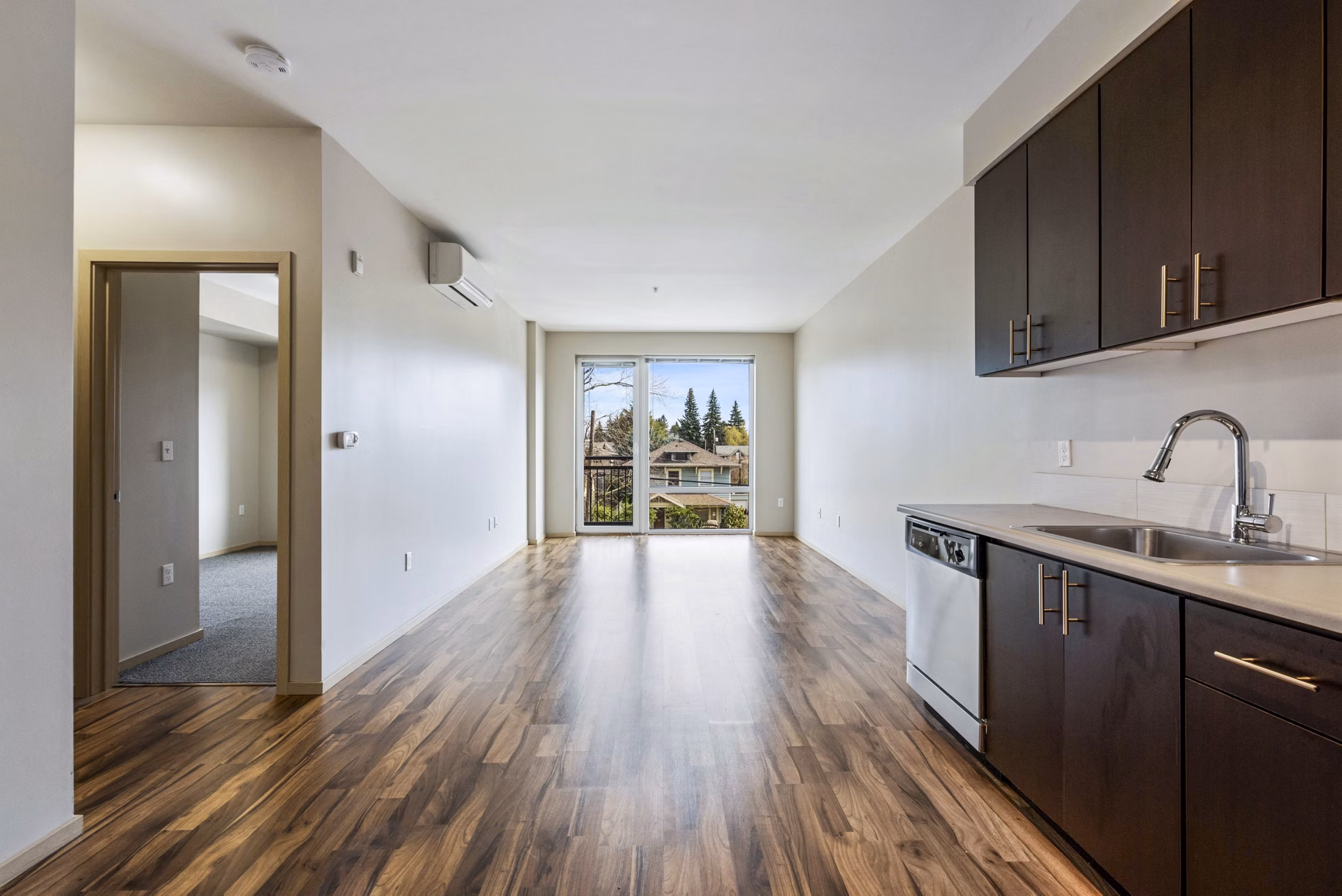 Modern kitchen featuring stainless steel appliances and granite countertops at Prescott Apartments