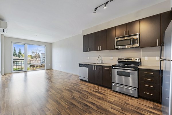 Modern kitchen with stainless steel appliances in Prescott Apartments
