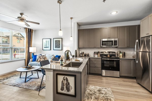 Modern kitchen with stainless steel appliances at Emerson at Red Oak Apartments