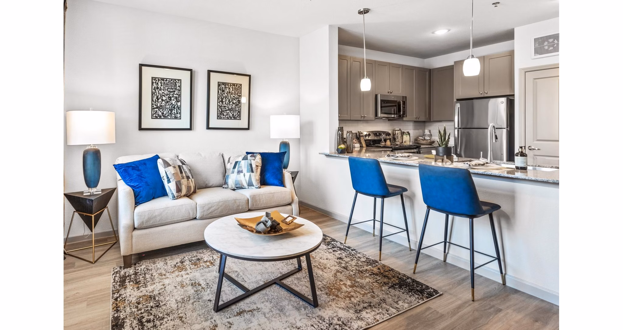 Cozy living room with modern furniture and large windows at Emerson at Red Oak Apartments, a luxury property by Greystar