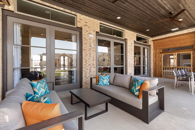 Cozy outdoor patio with comfortable seating at Emerson at Red Oak Apartments, perfect for relaxing and entertaining