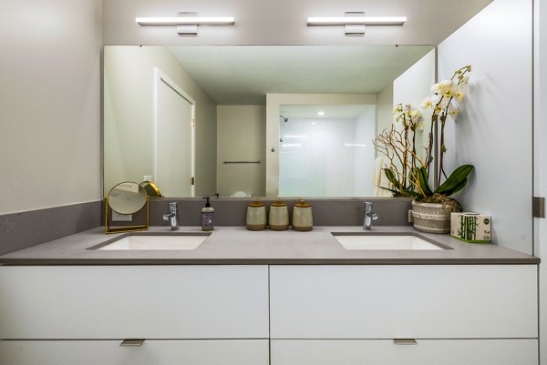 Modern bathroom featuring sleek fixtures at The Sur Apartments