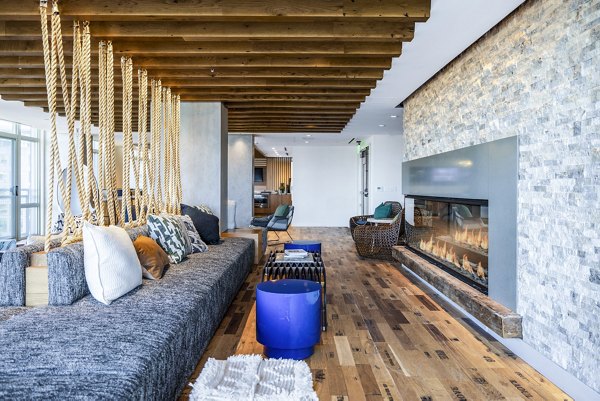 Clubhouse with modern decor at The Sur Apartments, offering luxurious communal spaces for socializing and relaxation near Greystar properties