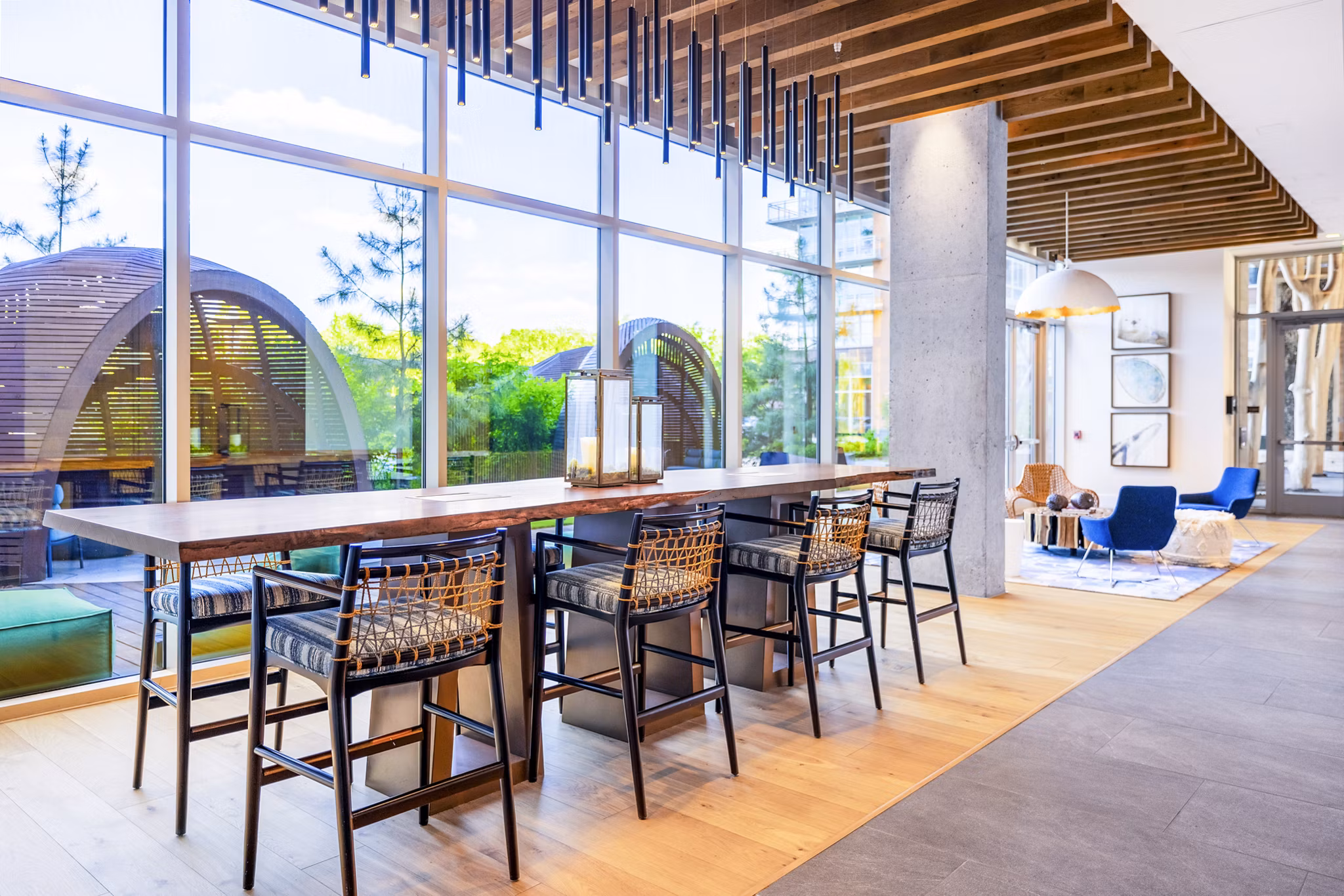 Clubhouse with modern design and seating areas at The Sur Apartments, offering luxury amenities in a vibrant community setting