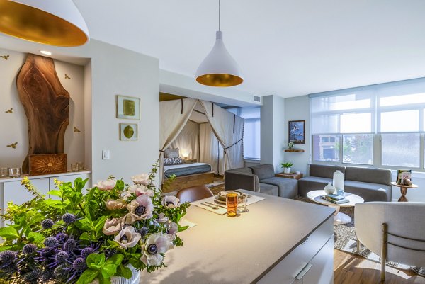 Modern kitchen with stainless steel appliances at The Sur Apartments, luxury living in the heart of urban life