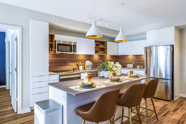 Modern kitchen with stainless steel appliances at The Sur Apartments