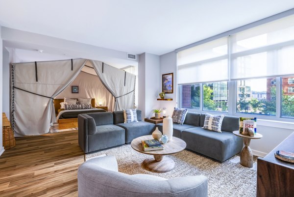 Modern living room with sleek furniture and large windows at The Sur Apartments