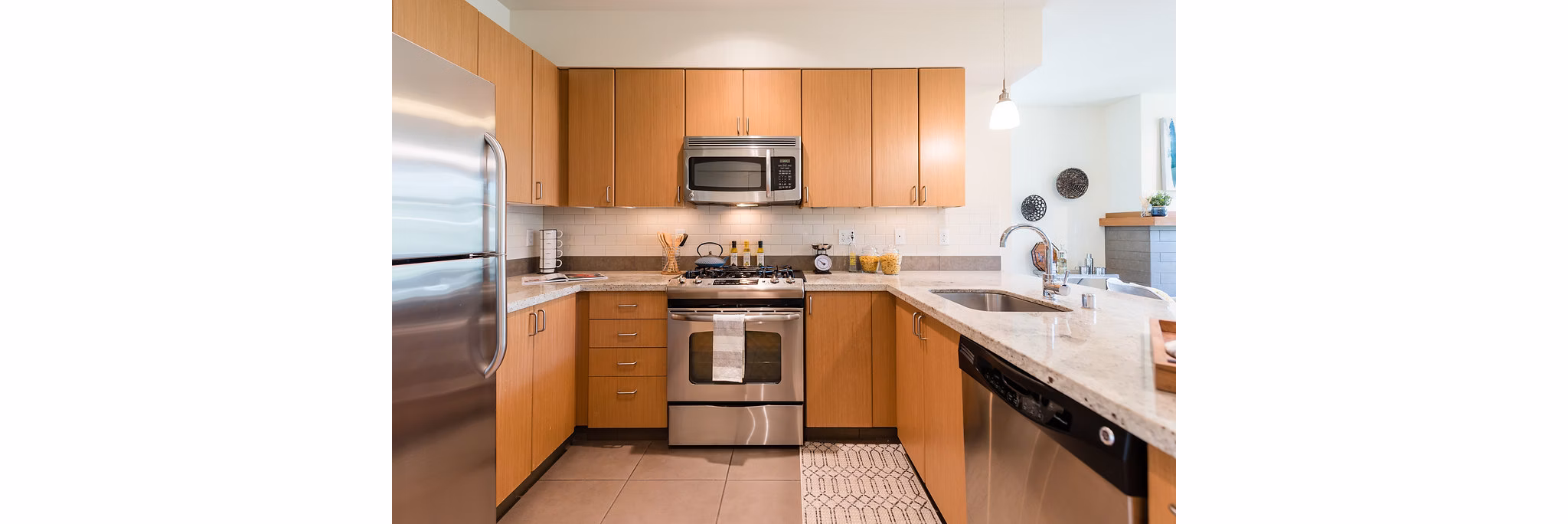 Modern kitchen with stainless steel appliances at Thornton Place Apartments, Greystar luxury apartments in Seattle
