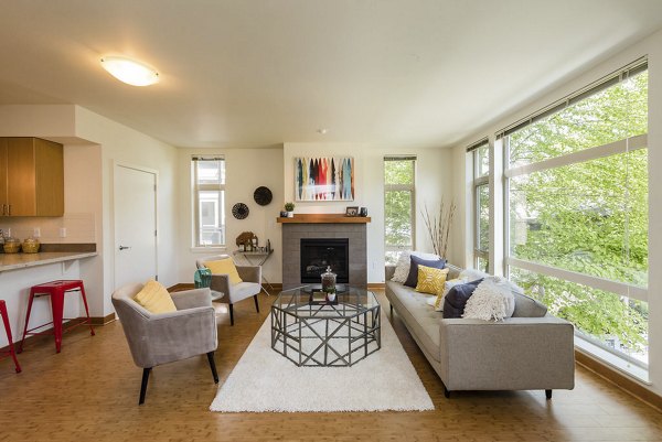 Spacious living room with hardwood floors and modern decor at Thornton Place Apartments