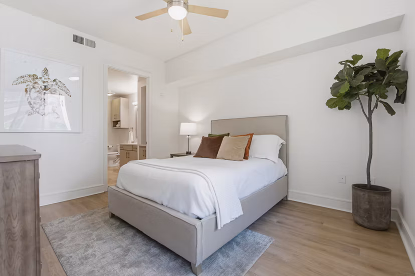 Cozy bedroom with modern decor at mResidences Miracle Mile Apartments