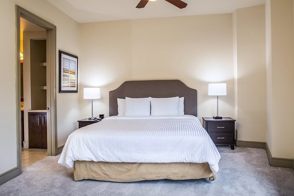 Cozy bedroom with modern decor at mResidences Miracle Mile Apartments