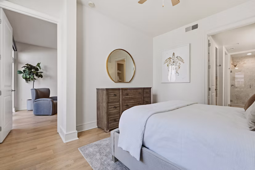 Spacious bedroom with modern furnishings at mResidences Miracle Mile Apartments