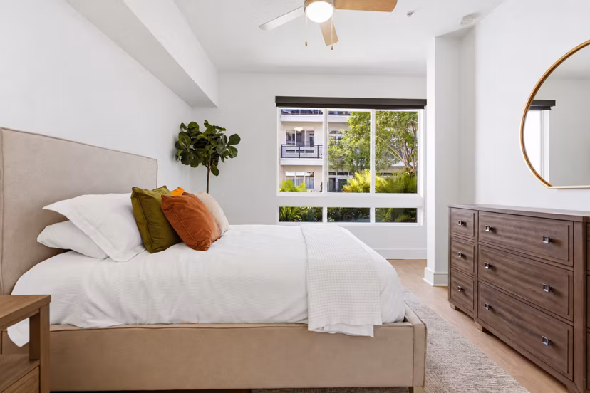 Cozy bedroom with modern decor at mResidences Miracle Mile Apartments
