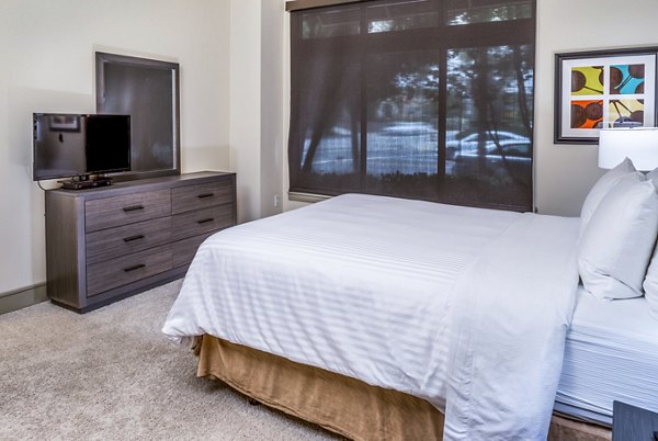 Cozy bedroom with modern decor at mResidences Miracle Mile Apartments