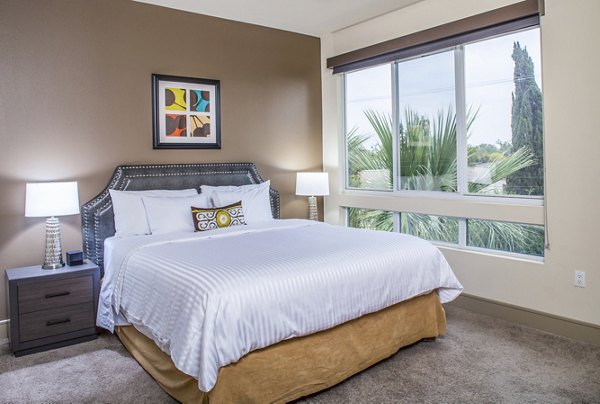 Luxurious bedroom with modern decor at mResidences Miracle Mile Apartments