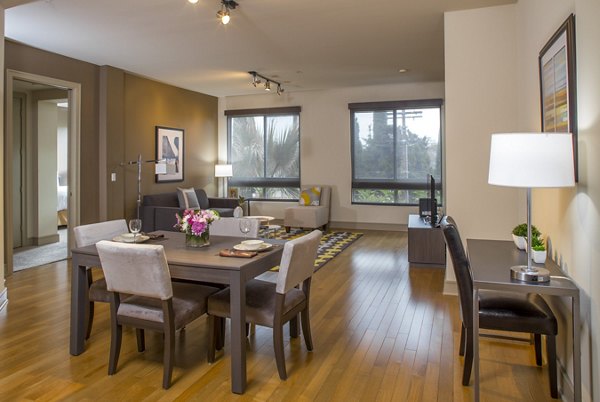 Dining area with modern dÃ©cor and chic lighting fixtures at mResidences Miracle Mile Apartments