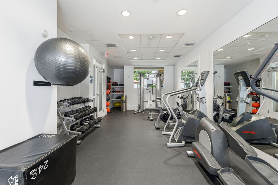 State-of-the-art fitness center at mResidences Miracle Mile Apartments with modern equipment for a complete workout experience