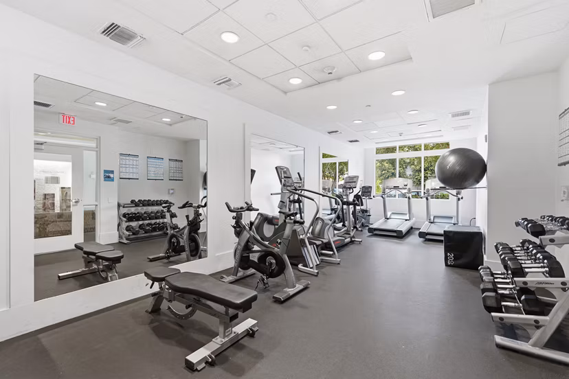 Fitness center with state-of-the-art equipment at mResidences Miracle Mile Apartments, offering luxury amenities
