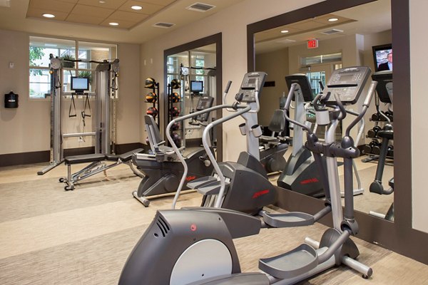 Fitness center with state-of-the-art equipment at mResidences Miracle Mile Apartments, offering luxury amenities