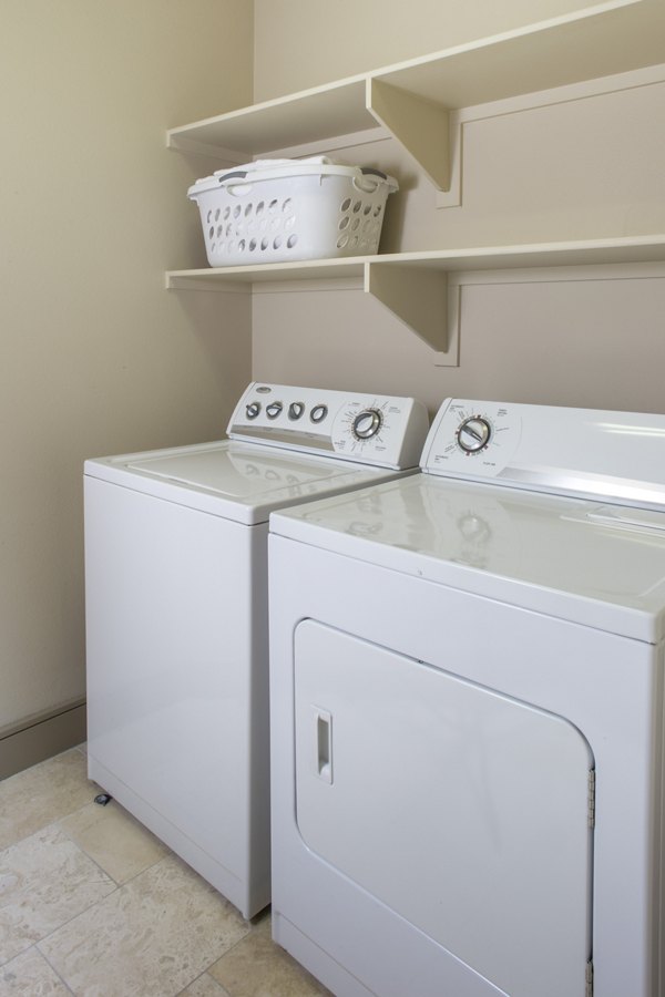 Laundry room with modern appliances at mResidences Miracle Mile Apartments