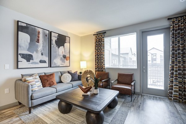 Living room with modern decor and natural light at Outlook Briargate Apartments, luxury property offering comfortable living spaces