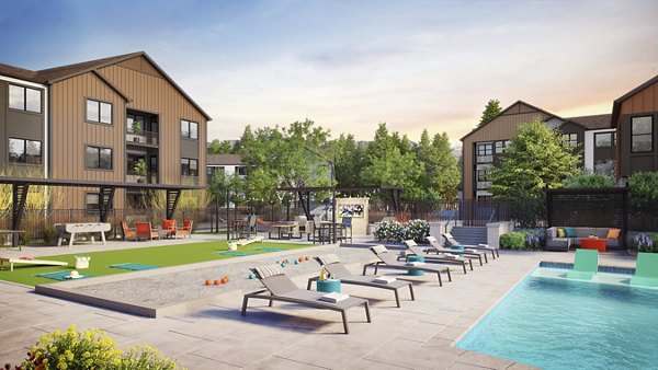 Inviting outdoor pool area at Outlook Briargate Apartments with lounge chairs and scenic views