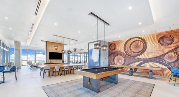 Modern game room with billiards and plush seating in Beckon Apartments' clubhouse