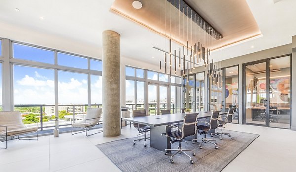 Modern clubhouse meeting facility at Beckon Apartments featuring sleek furniture and bright lighting
