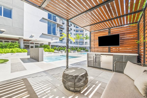 Poolside cabana at Crest at Pinecrest Apartments with luxurious seating and lush surroundings