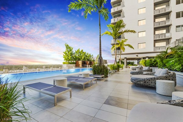 Crest at Pinecrest: Luxury pool with deckchairs and landscaping at upscale apartments