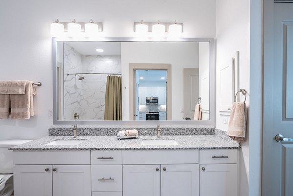 Bright bathroom with modern fixtures at Alexan Braker Pointe Apartments