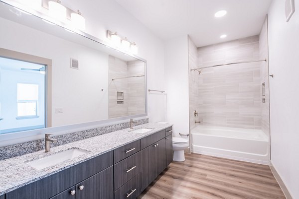 Luxurious bathroom featuring modern fixtures and spacious design at Alexan Braker Pointe Apartments