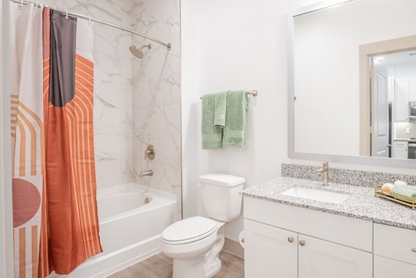 Bathroom featuring modern fixtures and tilework at Alexan Braker Pointe Apartments