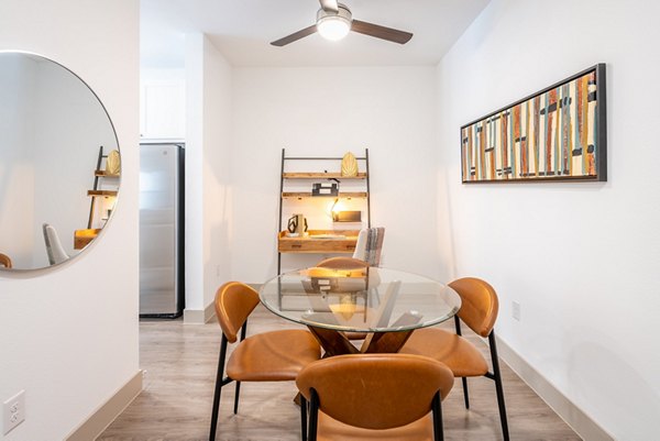 Dining area featuring sleek furniture and modern lighting at Alexan Braker Pointe Apartments, luxury living in Austin