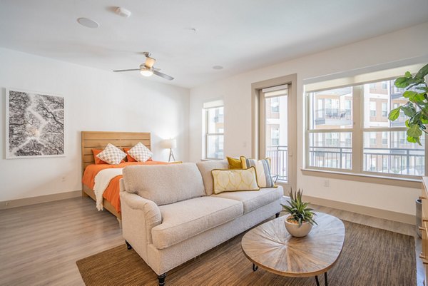 Stylish kitchen with granite countertops and stainless steel appliances at Alexan Braker Pointe Apartments