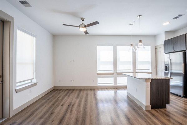 Spacious kitchen with stainless steel appliances at Alexan Braker Pointe Apartments