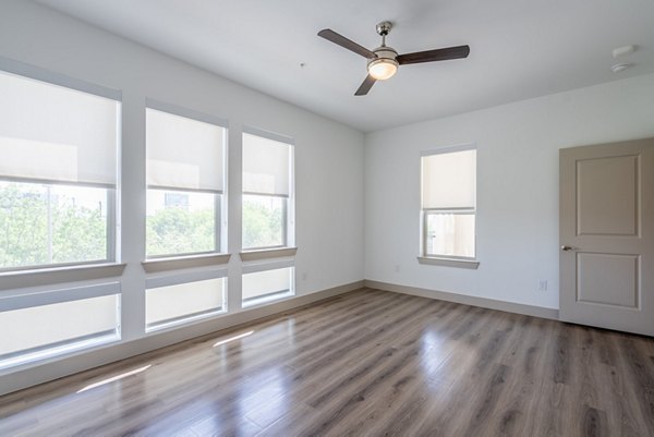 Modern living room with stylish decor and natural light at Alexan Braker Pointe Apartments