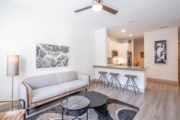 Modern living room with natural light and stylish decor at Alexan Braker Pointe Apartments