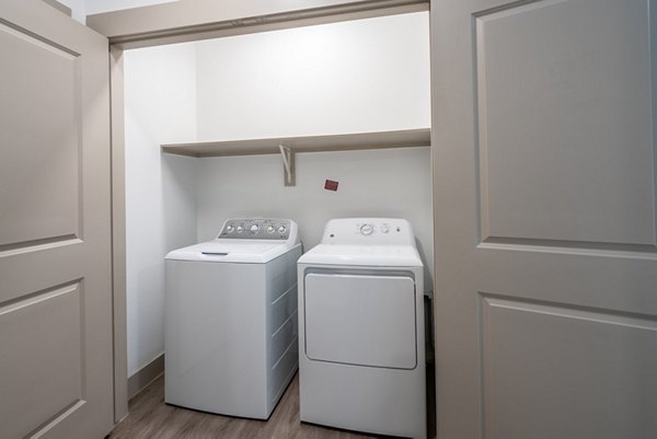 Laundry room featuring state-of-the-art appliances in Alexan Braker Pointe Apartments