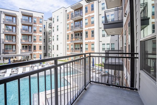 Stylish outdoor patio with modern seating at Alexan Braker Pointe Apartments, perfect for relaxation and gatherings