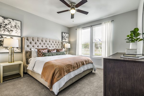 Spacious bedroom with stylish decor at Sage Stone Oak Apartments, part of Greystar's luxury apartment offerings