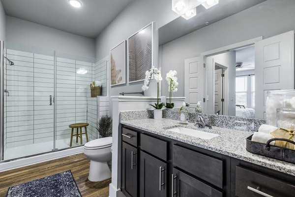 Luxurious bathroom with marble countertops at Sage Stone Oak Apartments
